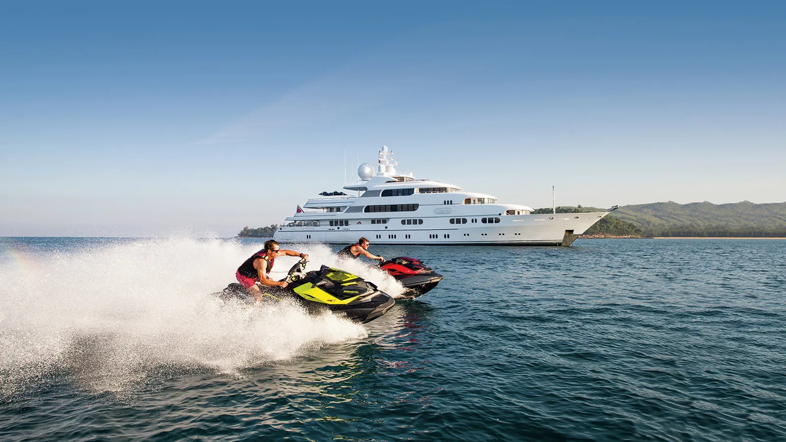 Apoise (now Titania) on the water (jet skis running next to)