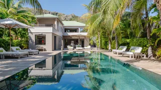 Villa K at Anse des Cayes is a four-bedroom beachfront retreat with open-plan living and direct access to the beach