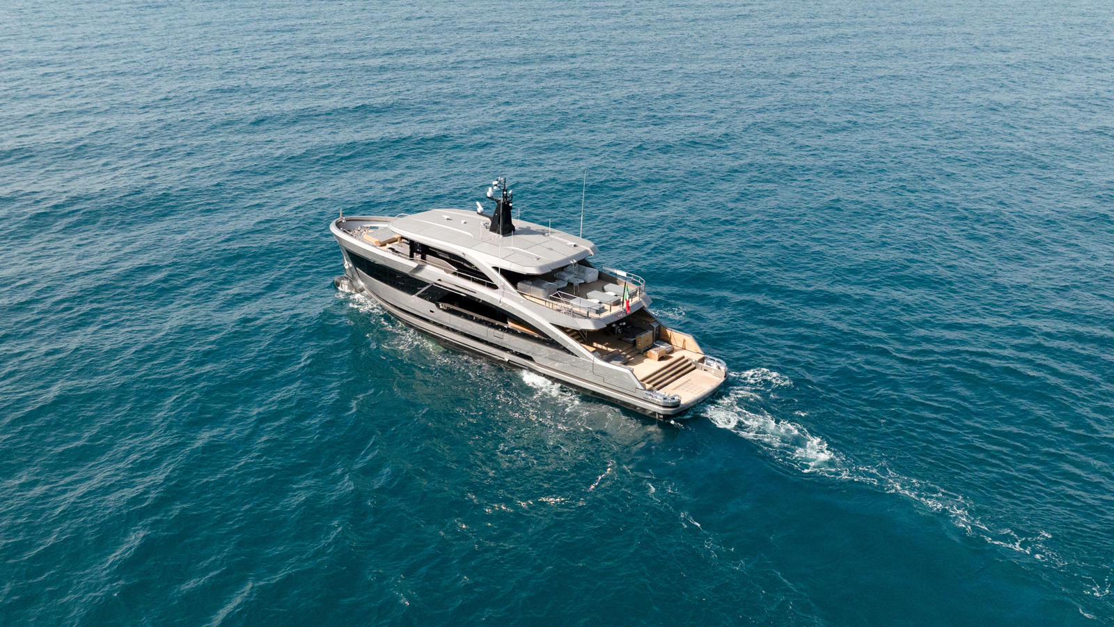 Matilde 7 main deck outdoor space with sliding glass panels and teak furnishings